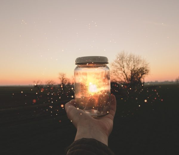 person holding glass jar